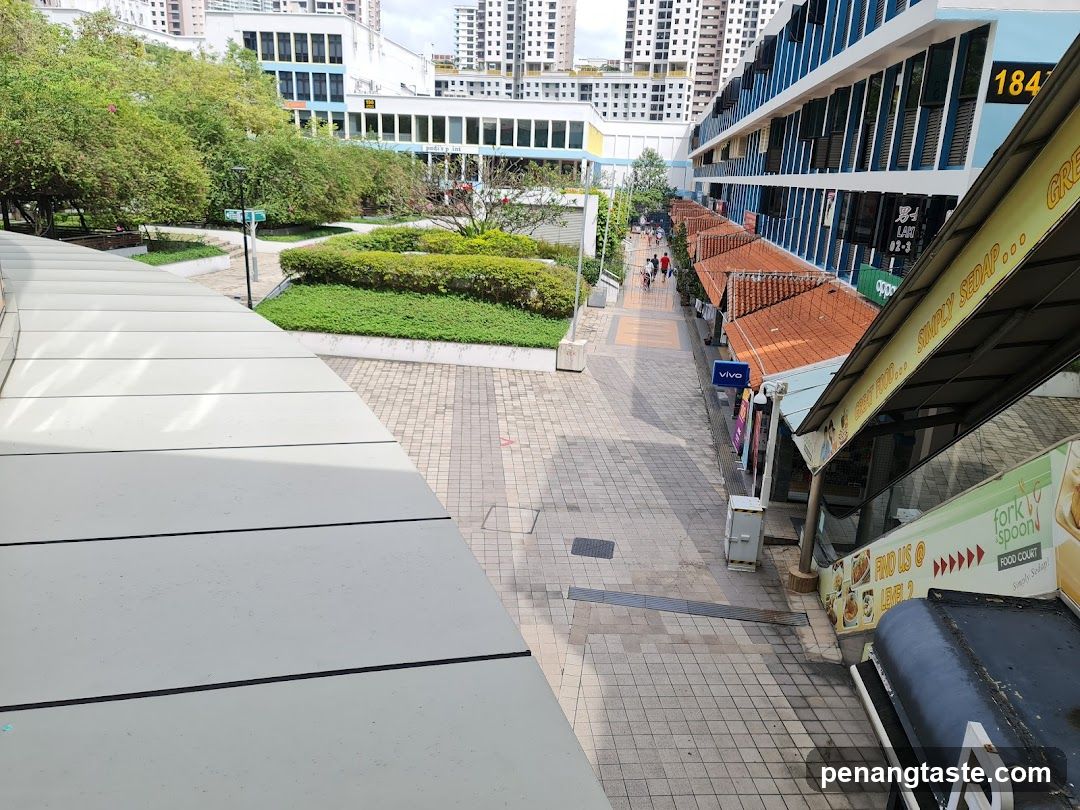 Outdoor shopping area with storefronts and walkway