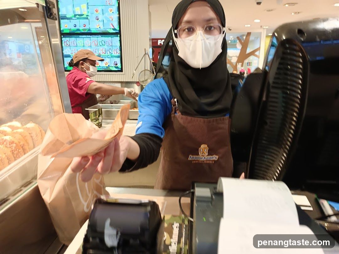 Auntie Anne's Staff Serving Customer