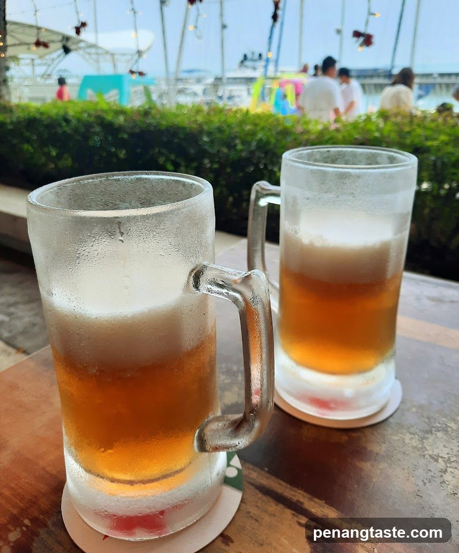 Two cold beer mugs on a table outdoors