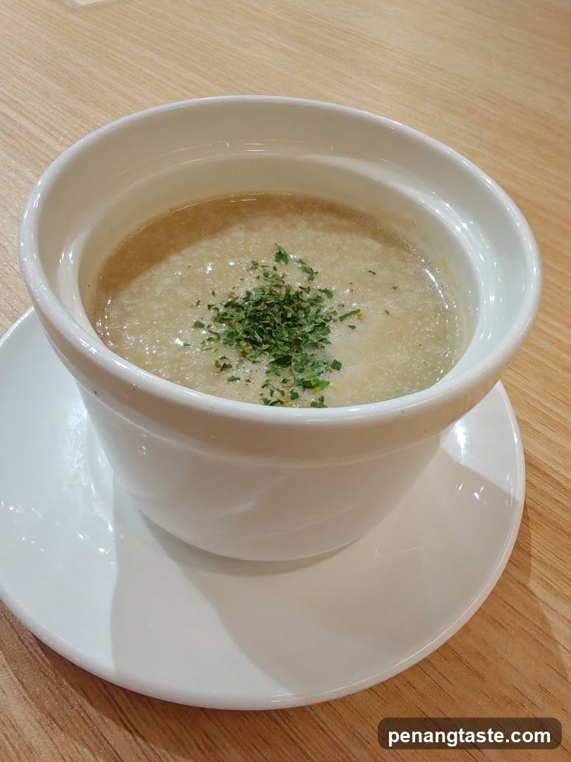Soup in white bowl on wooden table