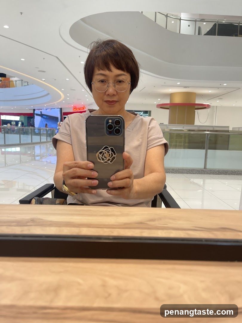 Woman taking selfie in shopping mall