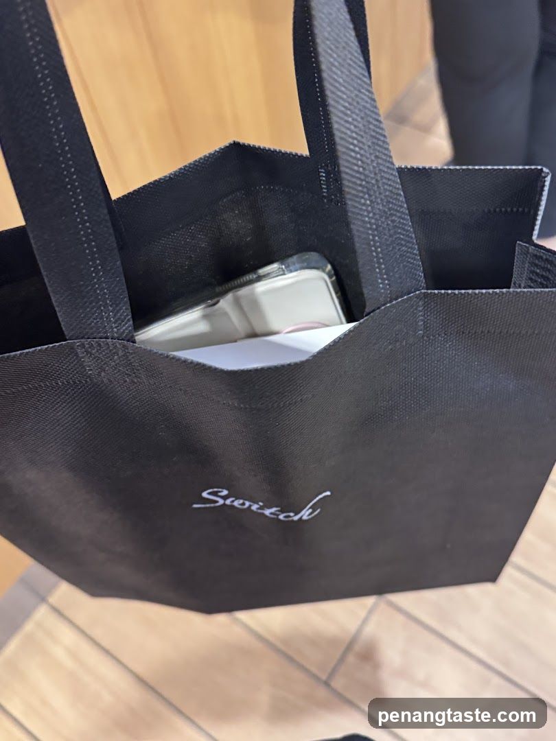 Black tote bag with 'Switch' logo