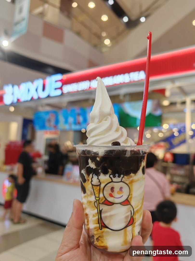 Hand holding dessert in shopping mall