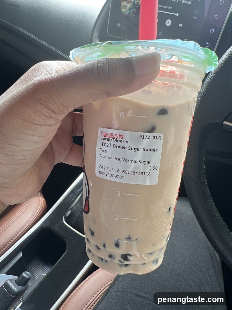 Hand holding bubble tea in car