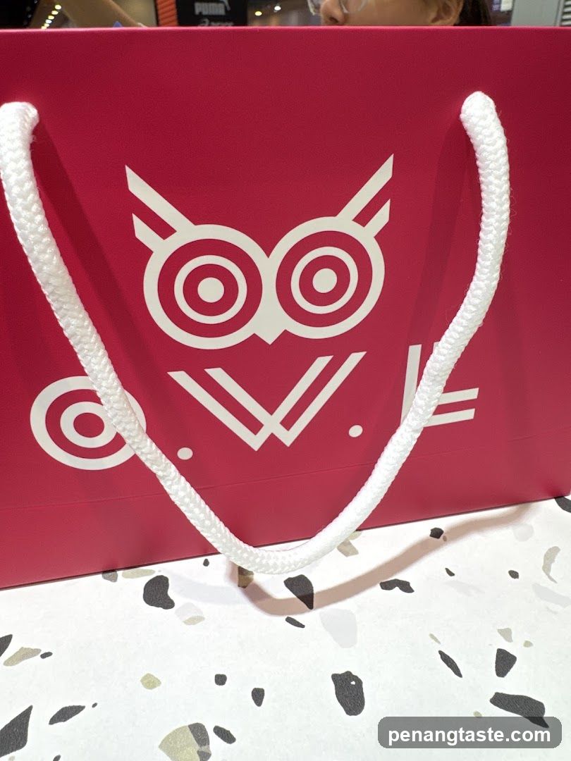 Red shopping bag with owl logo