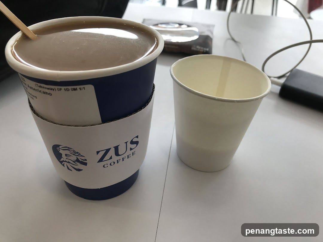 ZUS Coffee Cup and Empty Cup on Table