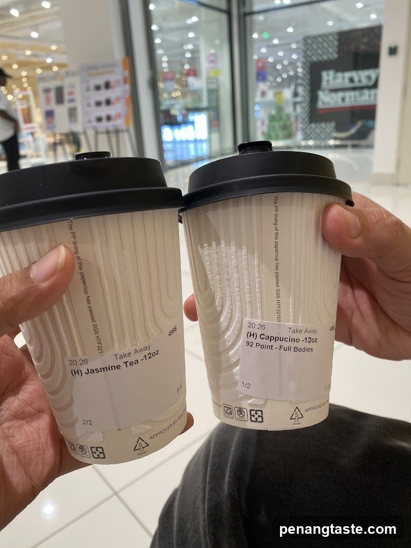 Two coffee cups held in hands