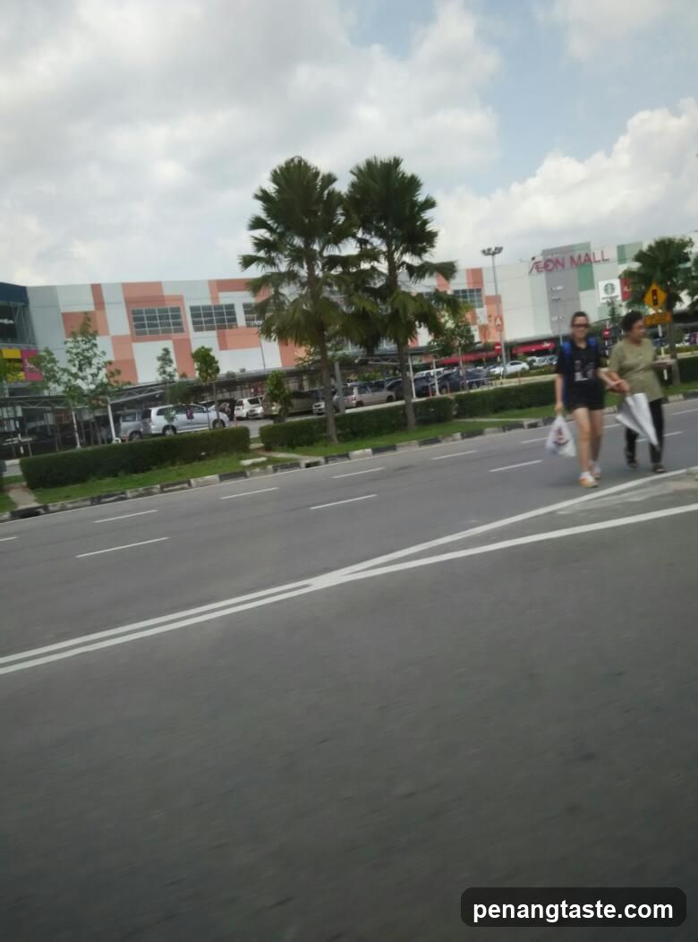 People crossing street near AEON MALL