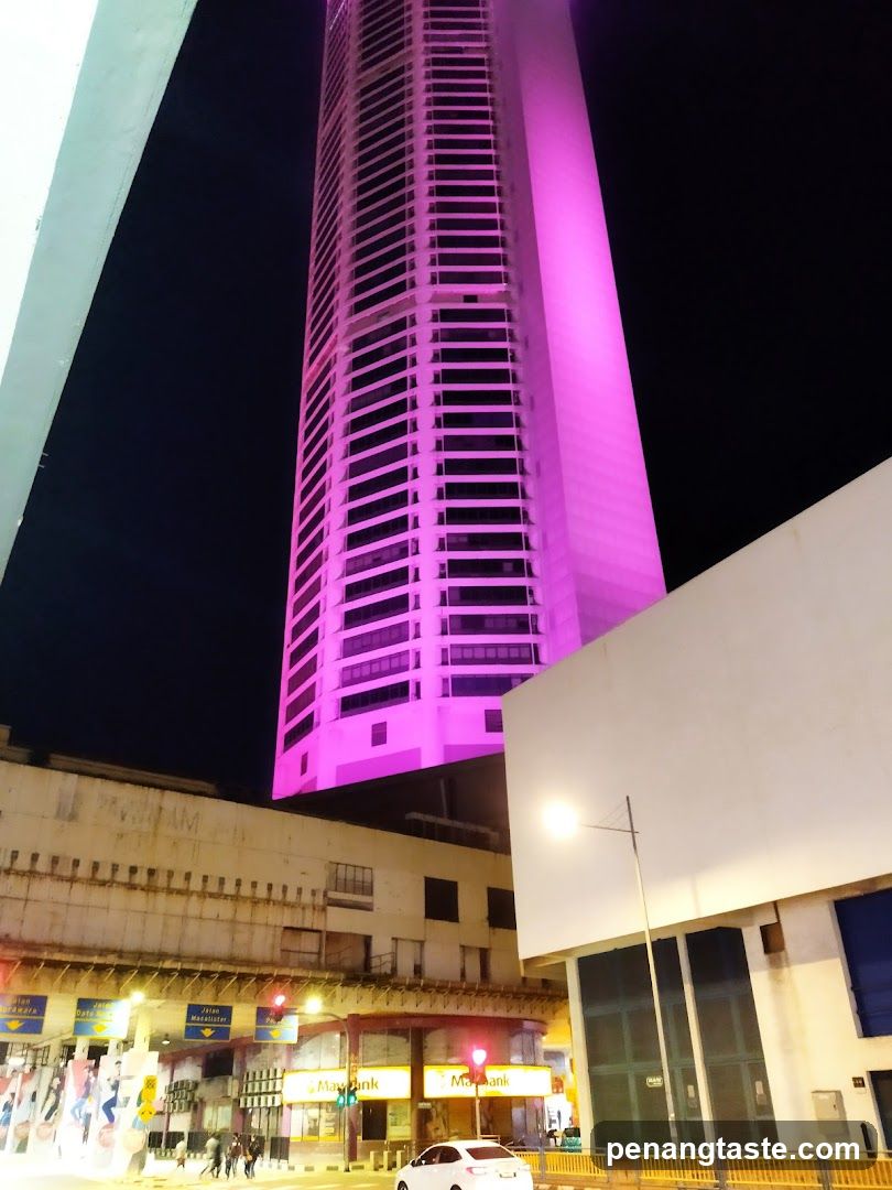 Nighttime urban scene with illuminated skyscraper