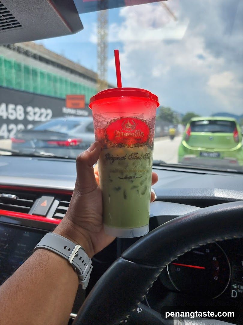 Hand holding iced tea in car