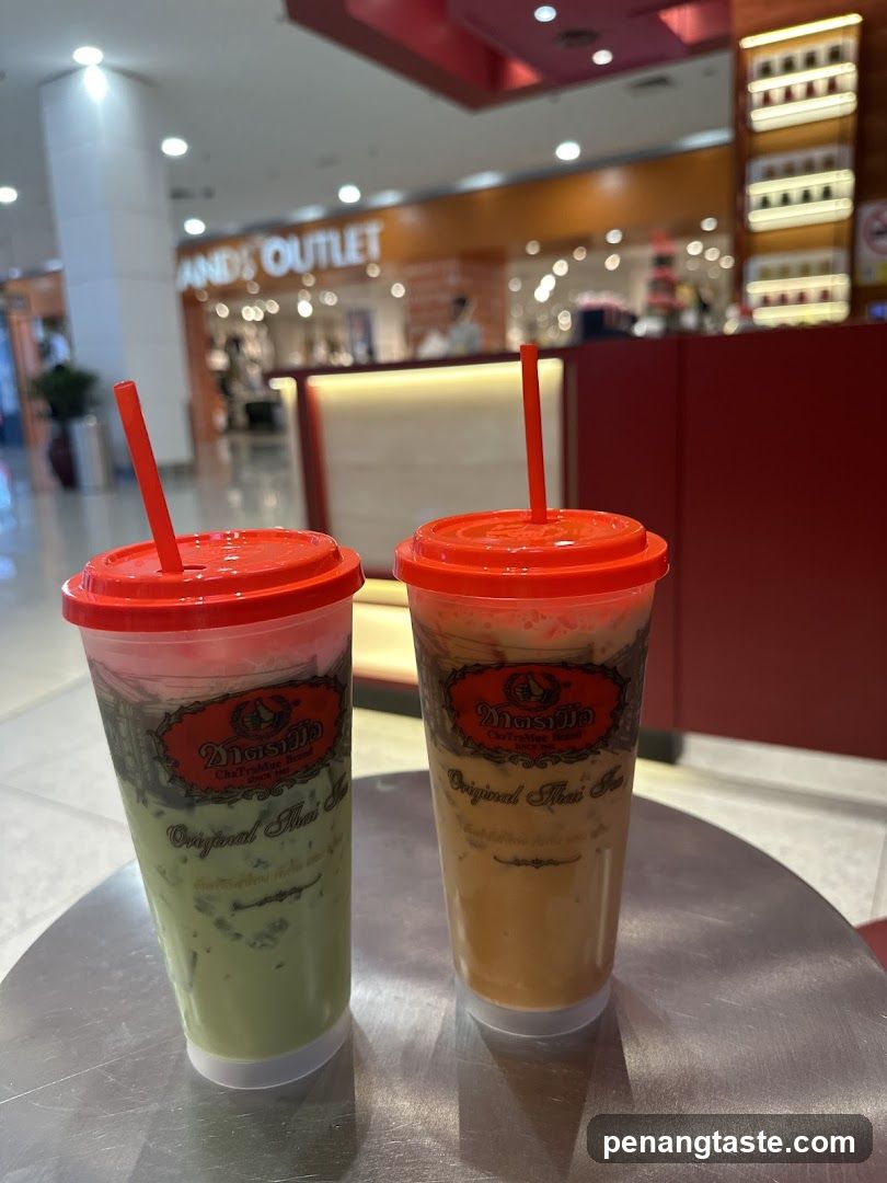 Two iced Thai teas on a table in a shopping mall