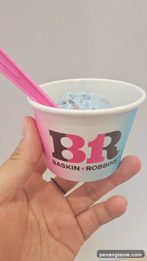 Hand holding Baskin-Robbins ice cream cup