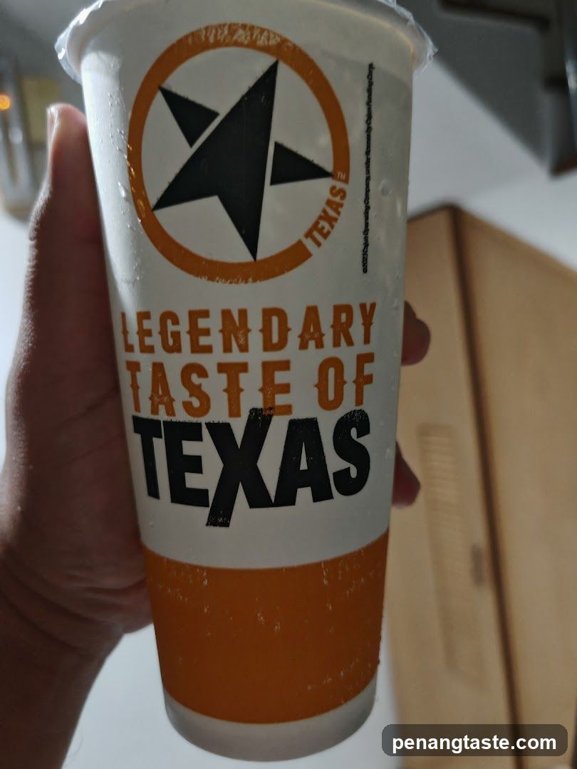 Hand holding Texas-themed beverage cup