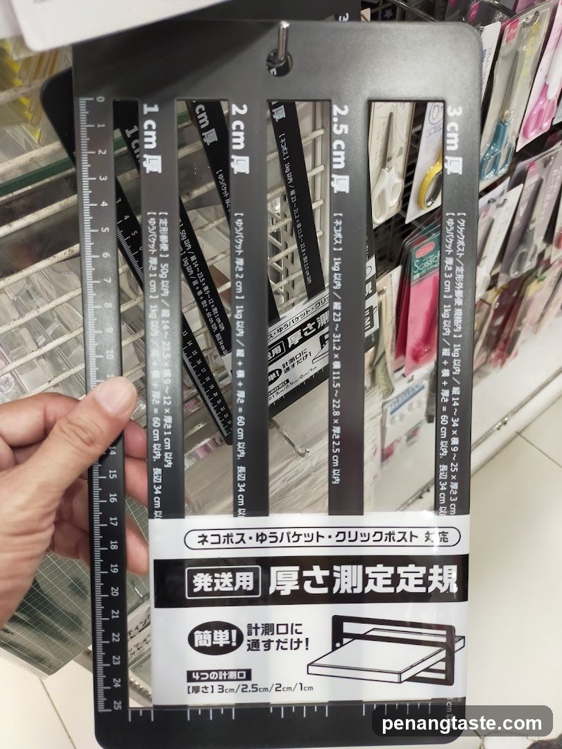 Hand holding thickness measurement ruler