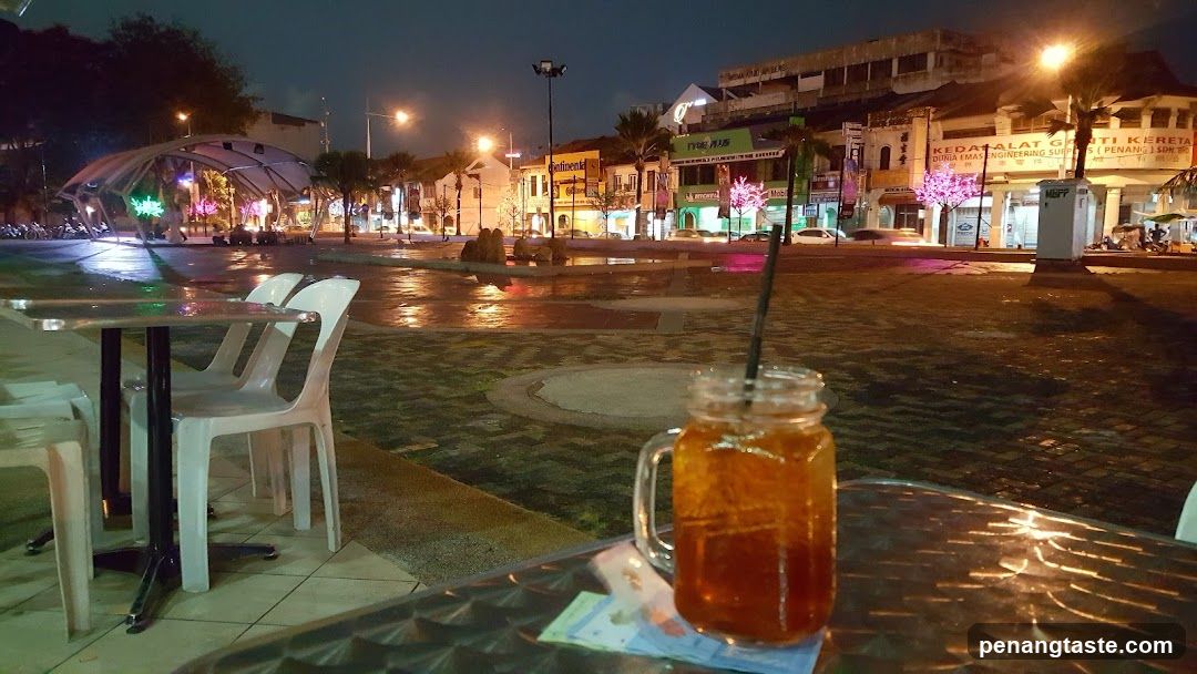 Nighttime outdoor seating area with beverage