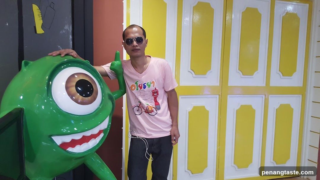 Man with green one-eyed character statue