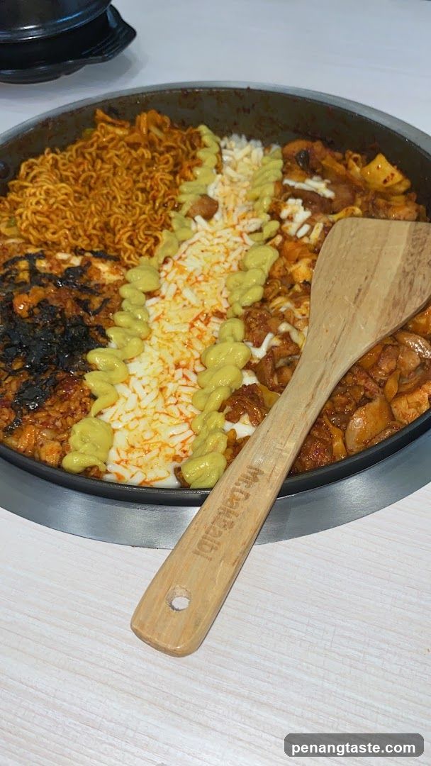 Food dish in pan with wooden spoon