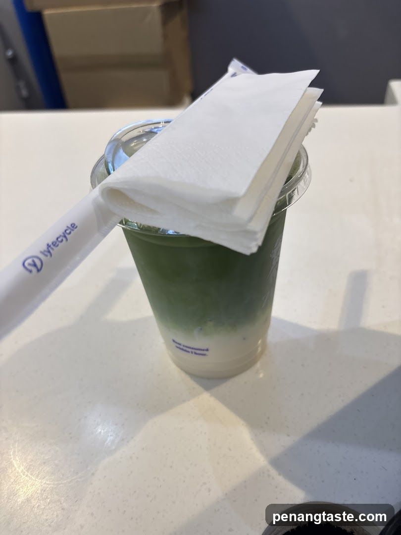 Matcha beverage with straw and napkin