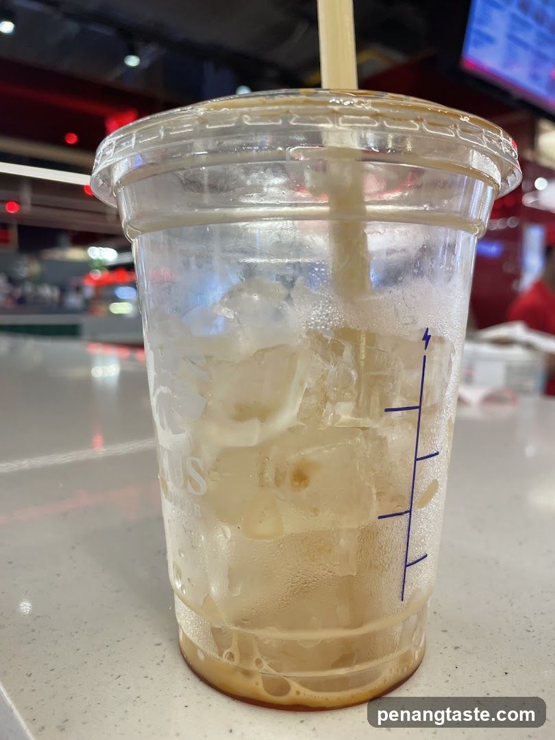 Iced beverage in plastic cup with straw