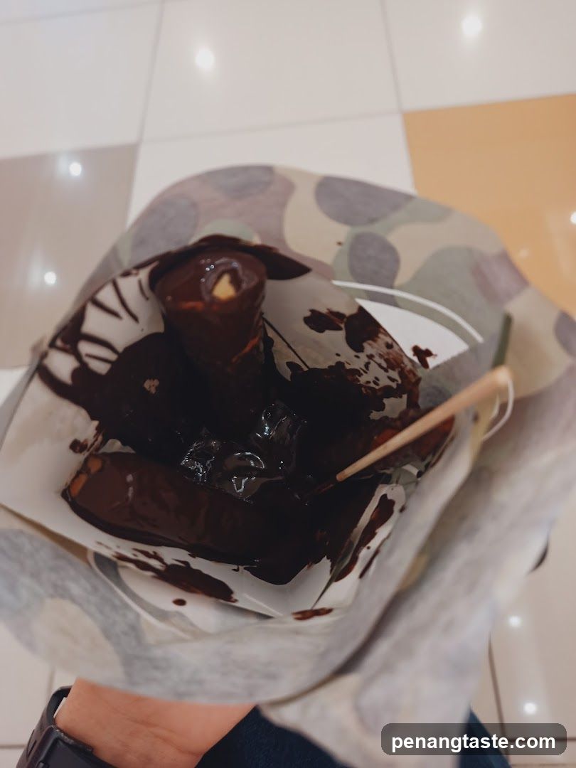 Chocolate-covered dessert in paper wrapper