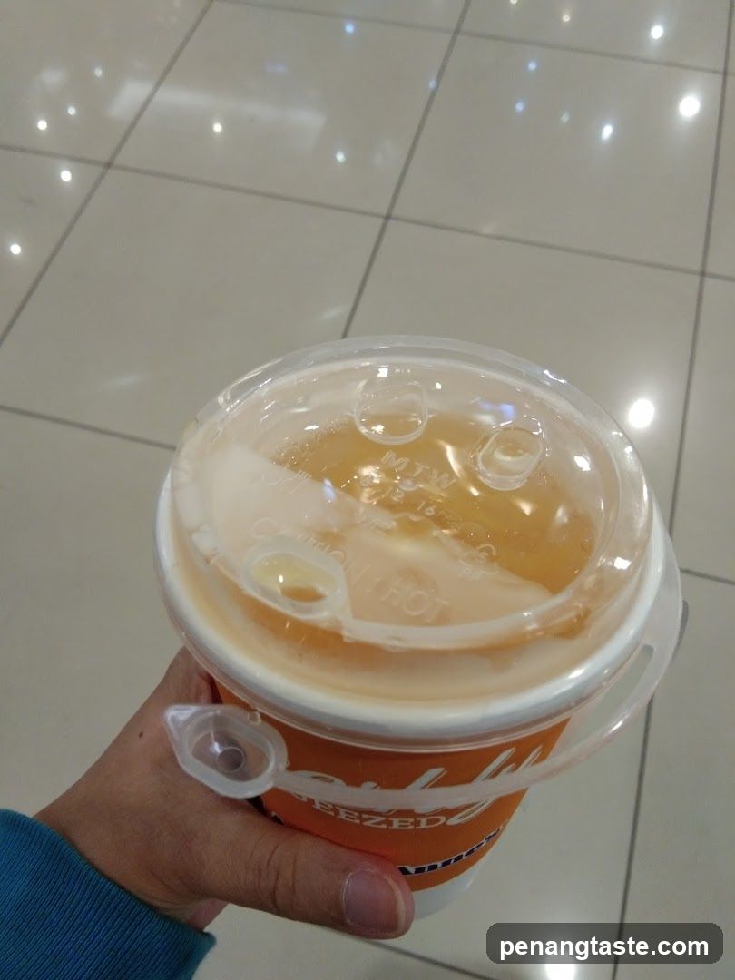 Hand holding a beverage cup