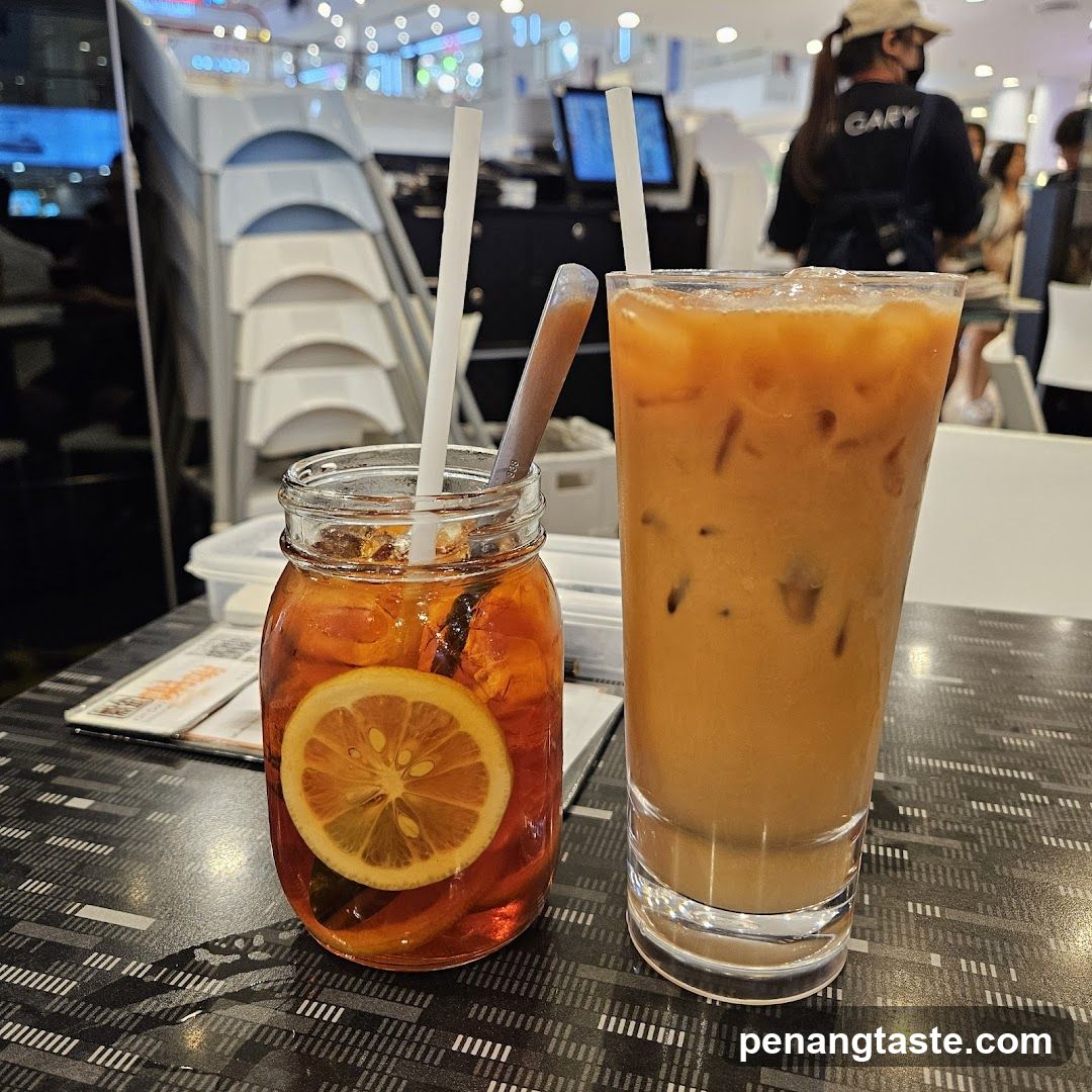 Two iced beverages on a table in an indoor setting
