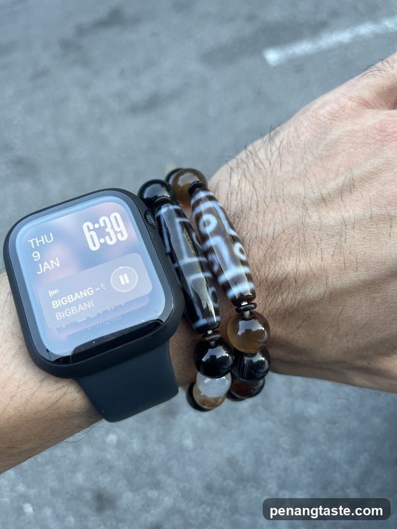 Hand wearing smartwatch and beaded bracelet
