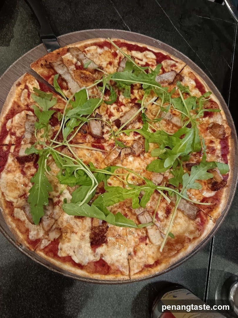 Pizza with arugula and meat toppings