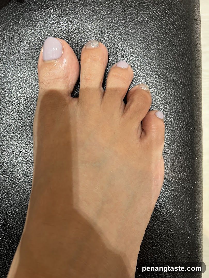Foot with Nail Art on Black Surface