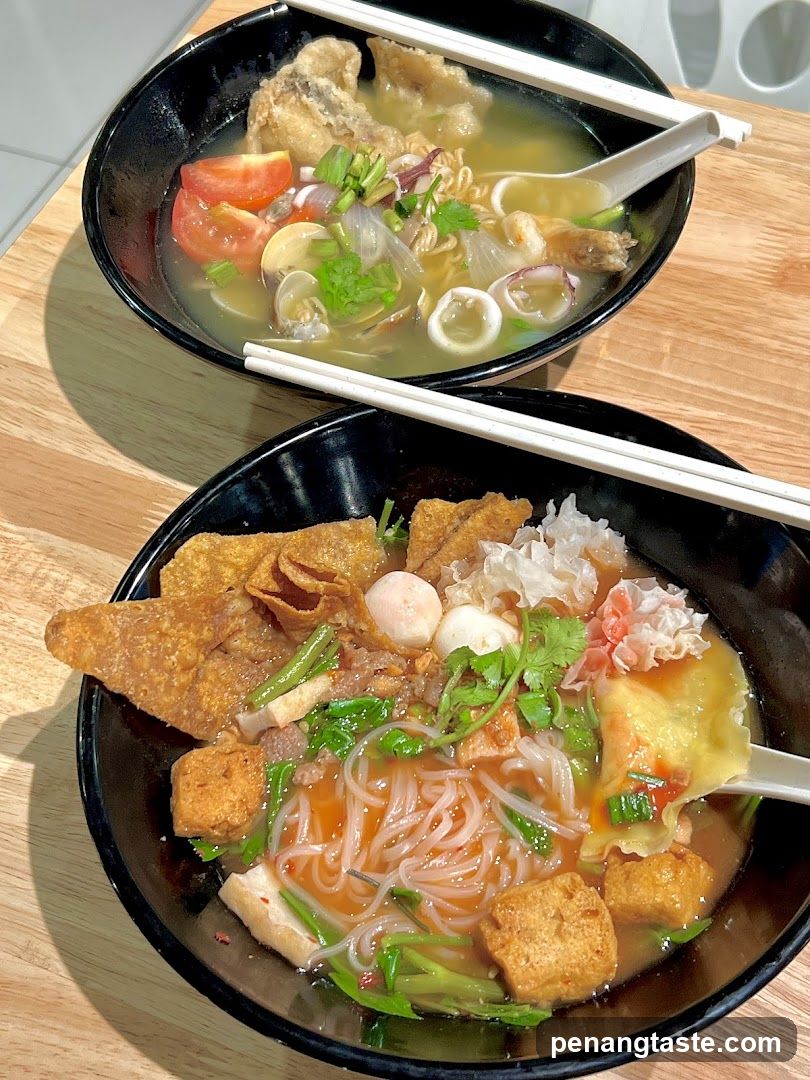 Two bowls of noodle soup on a wooden table