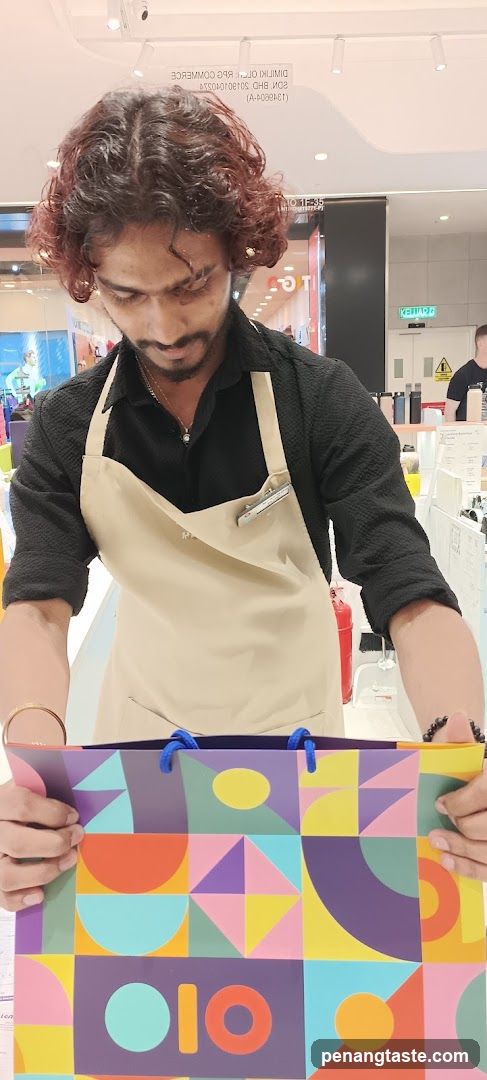 Staff holding shopping bag inside store