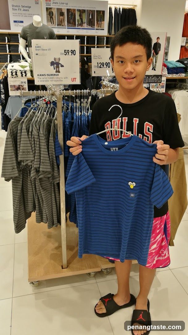 Shop Interior with Customer Holding Shirt