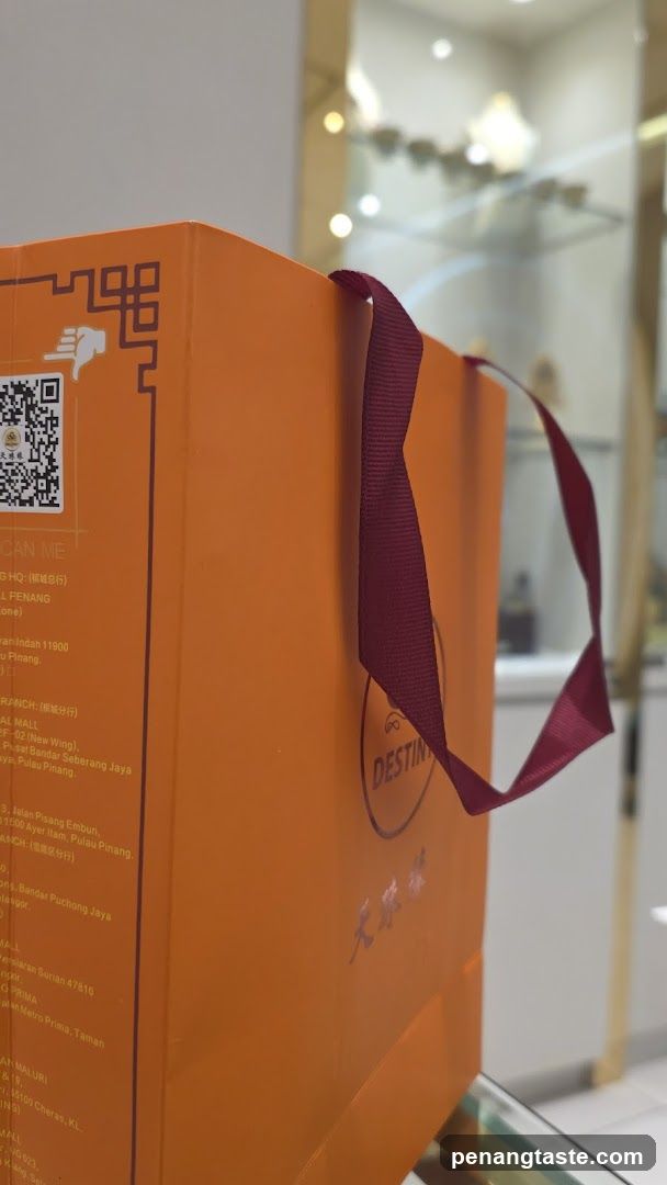 Orange shopping bag with red handle