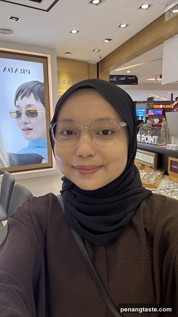 Woman wearing glasses and hijab in a store