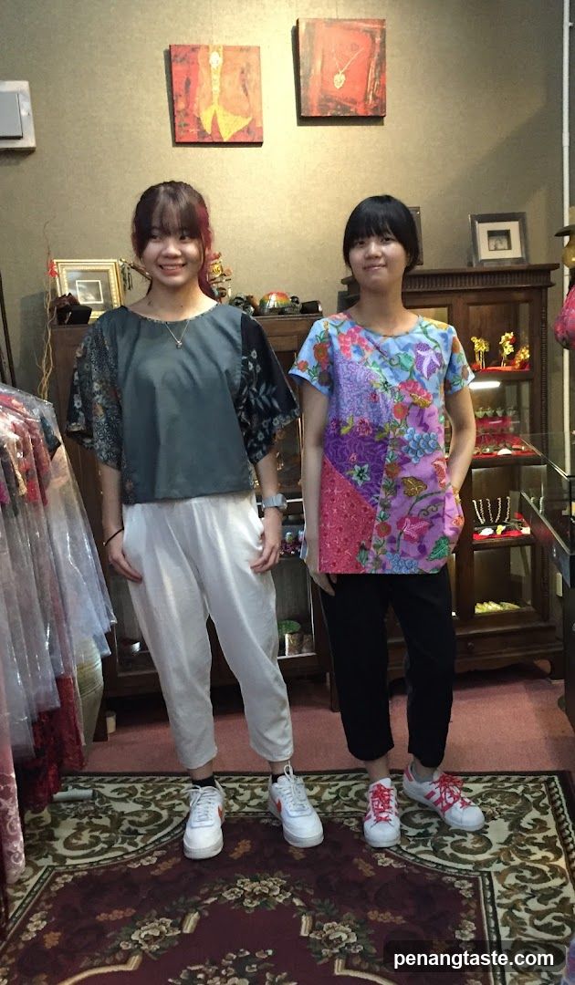 Two young women posing in a boutique
