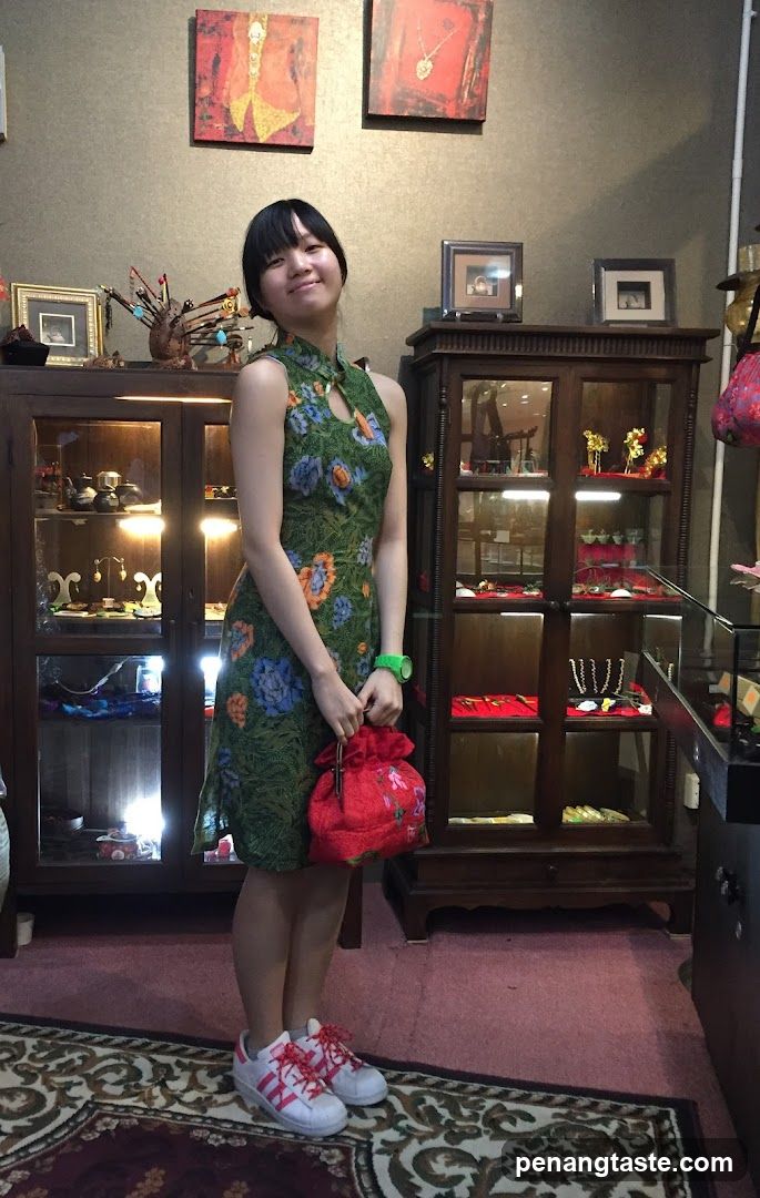 Woman in a floral dress holding a red bag