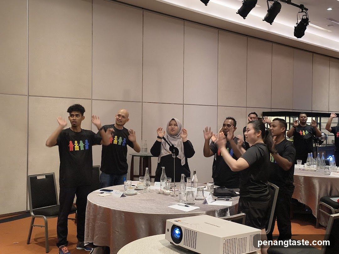 People Waving in a Conference Room