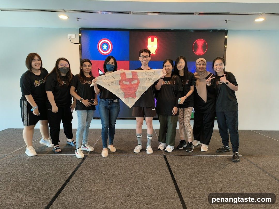 Team Poses with Marvel Banner