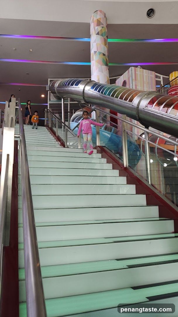 Children playing on a colorful indoor playground