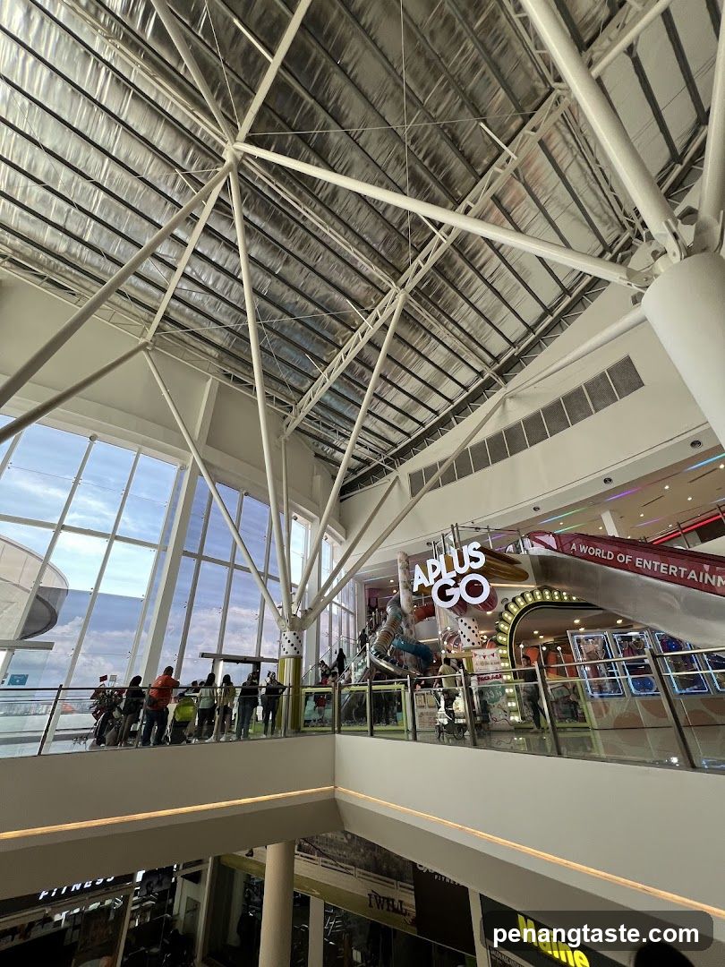 Interior of a modern shopping mall with a large atrium and entertainment area