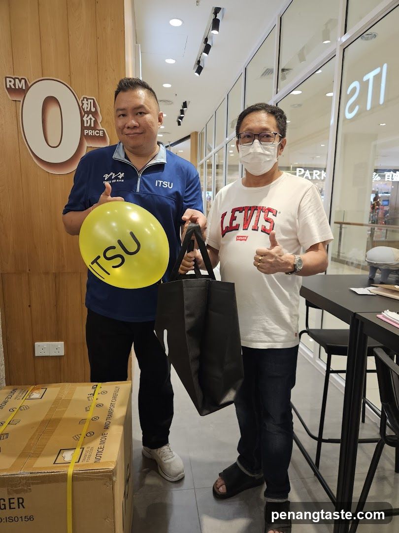 Two men posing with a balloon and a bag