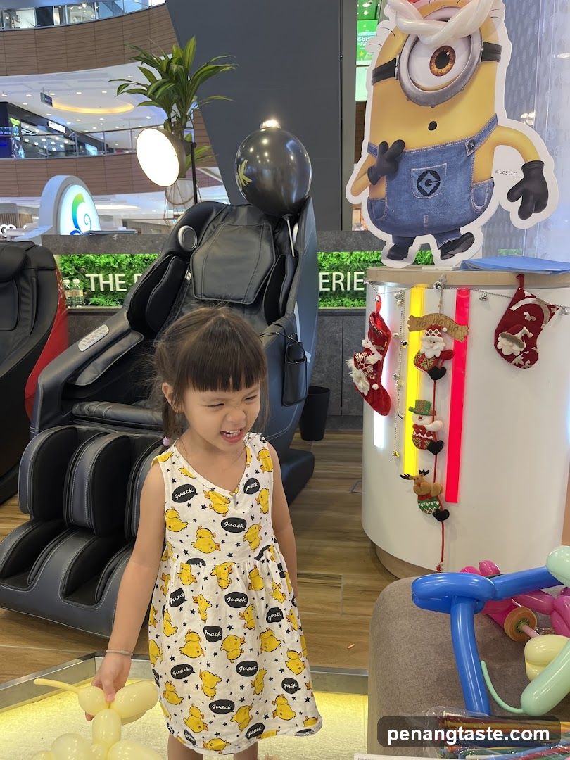 Child in front of massage chairs and Minion cutout