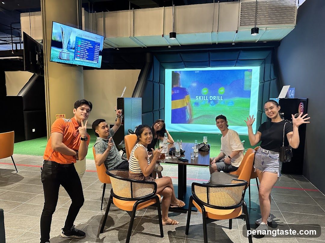 Group enjoying a virtual golf simulator