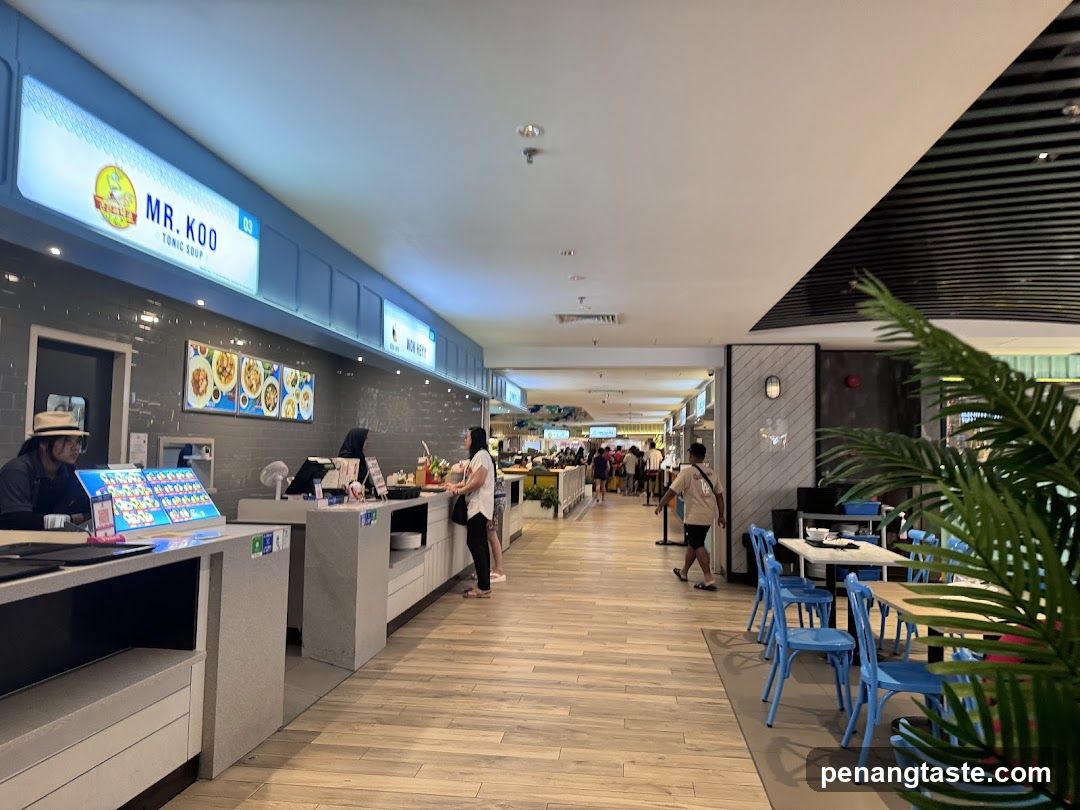 Food court with various stalls and seating areas