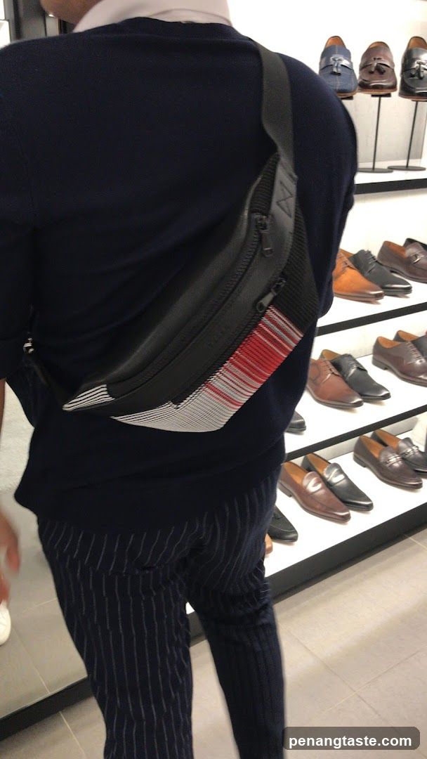 Man wearing a fanny pack in a shoe store