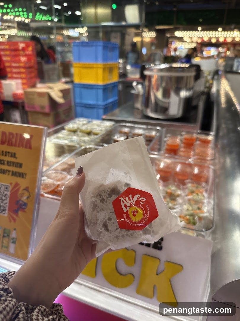 Hand holding food item at food stall