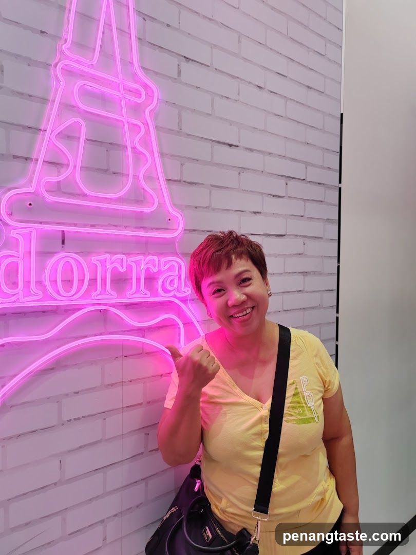 Person posing with neon sign
