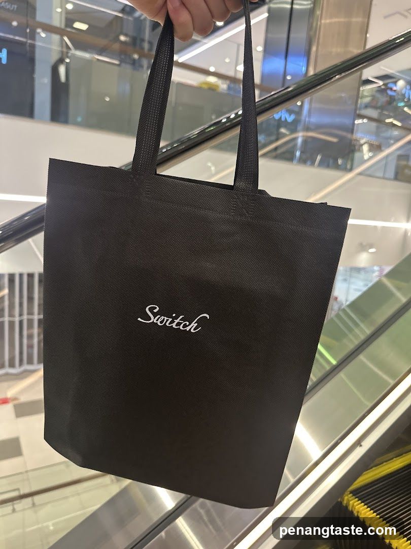 Black tote bag with 'Switch' logo