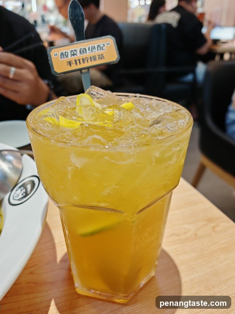 Cup of Yellow Drink with Ice and Lemon
