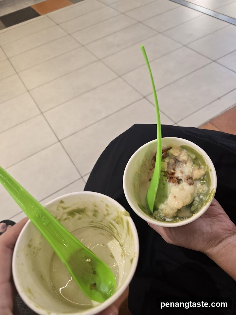 Two cups of food with green spoons